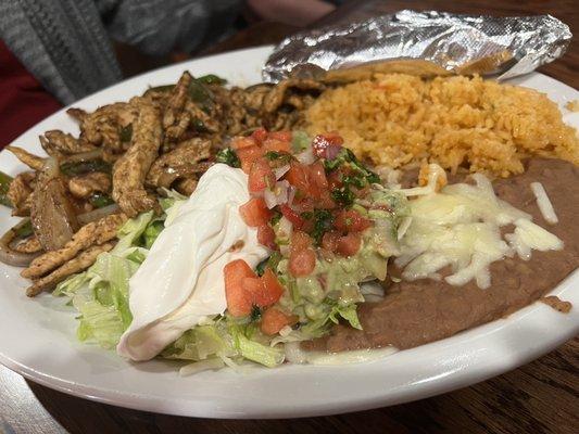 Chicken fajita, rice, and refried beans.