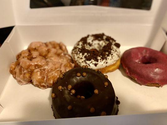 From L to R: peach fritter, chocolate malt with CBD, Oreo glaze, potato donut with blueberry glaze.