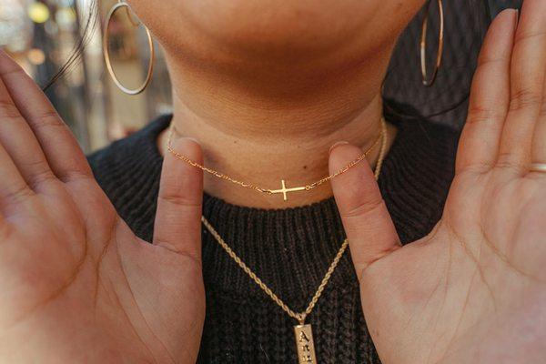 yellow gold permanent necklace with cross connector.