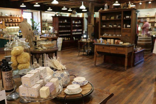 View of the lovely bath bombs, candles, and some decor, looking towards the back of the shop.