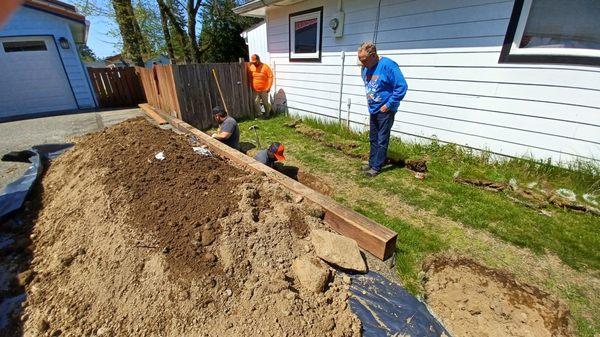 Digging out the dirt to get to the sewer line.