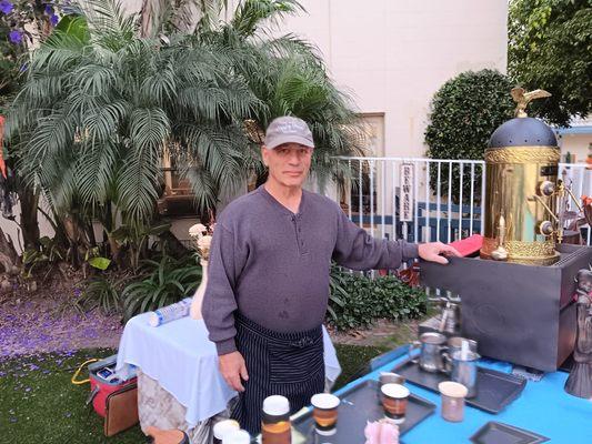 Ken and Julie, two residents of Friendship Manor providing our espresso catering services outdoors by the pool.