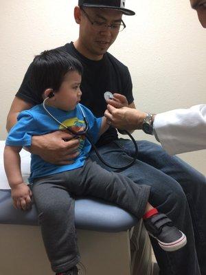 Dr. Arasheben letting my son use the stethoscope to listen to daddy's heart. Awww.