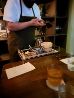 Prepping the caviar hand roll for someone else