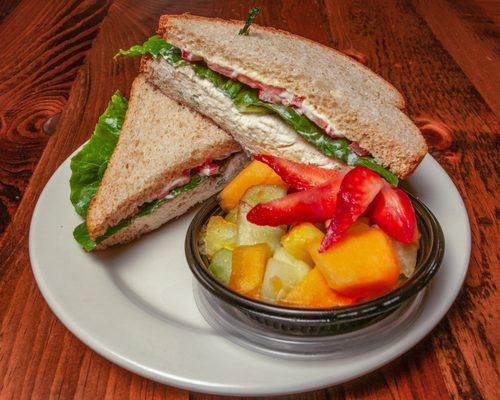 Homemade chicken salad on freshly baked bread with fruit