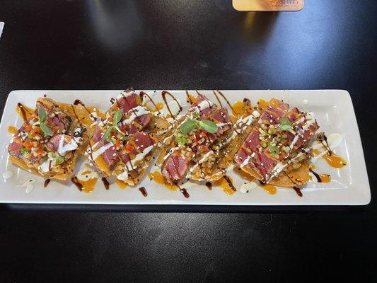 Ahi tuna and flavorful spices in rice on egg roll crisp.