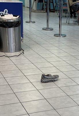 Shoe in the middle of the floor.