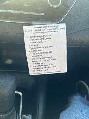 This note was taped to the dashboard, indicating additional fees for being early, late, or dropping off at another site.