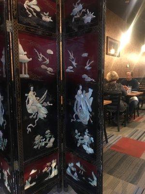 Beautiful screen and art in dining room