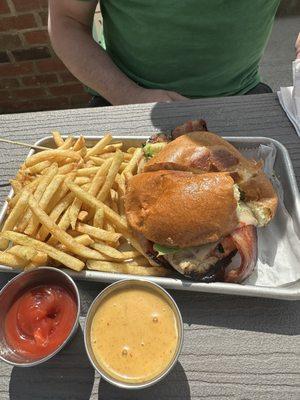 Grilled chicken avocado sandwich with fries.