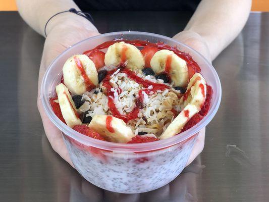 Coconut Matcha parfait, with chia seeds and topped with fresh strawberries, bananas, blackberries and roasted coconut flakes