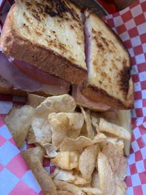 Ham Turkey and bacon sandwich with chips