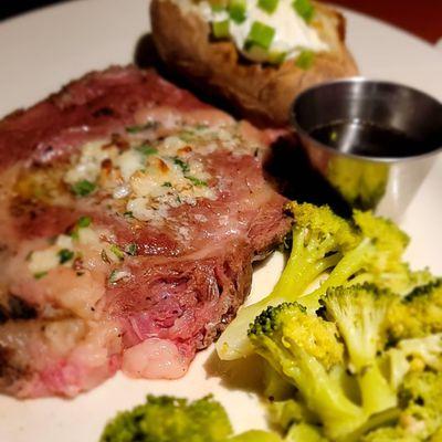 Prim rib with broccoli and baked potato.