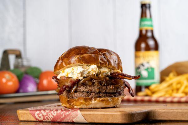 Beer cheese and bacon burger on a locally-baked pretzel bun