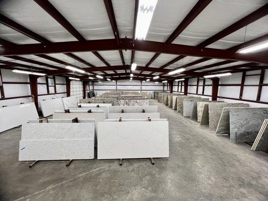 Priceless Granite indoor warehouse now includes  full slabs of quartz!