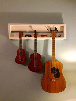 I recently built this custom shadow box to display our family instruments. One of a kind, made to hold a my guitar and two ukes.