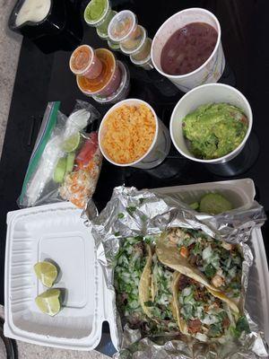 Tacos (L to R): carnitas, barbacoa de res, chorizo and shrimp. Some of the sauce goes with the papusas that are a snack later