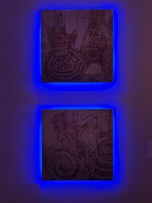 Property Butler executed accent lighting behind two Gibson Guitar pieces of art.