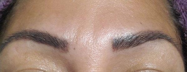 Microblading eyebrows.