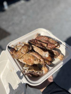 Half of a chicken (bottom) and half a rack of ribs (top)