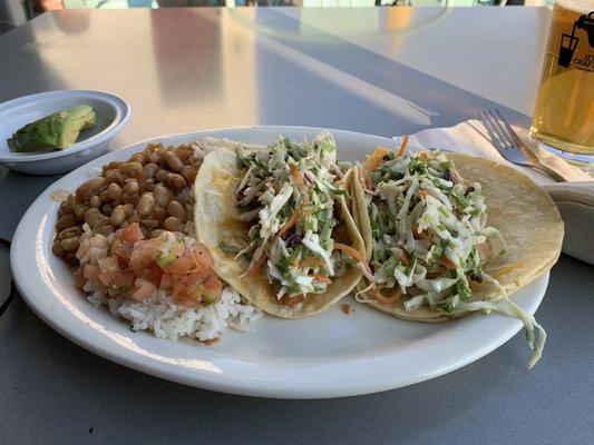 A flounder and shrimp taco platter with spicy beans rice and pico