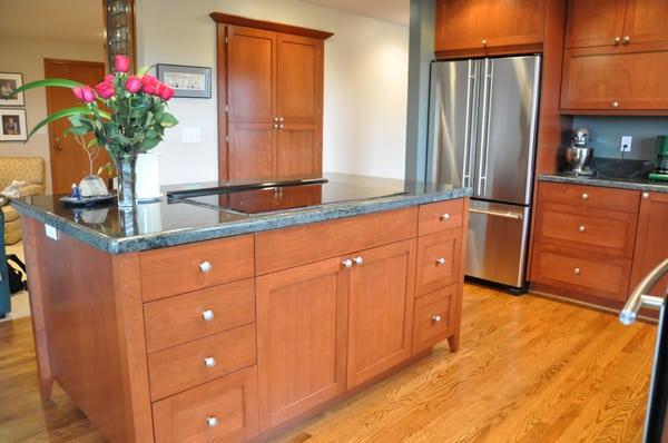 Transitional cherry island in this frameless cabinetry kitchen.