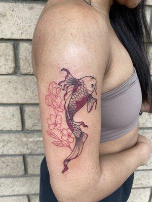 Koi fish with red flowers on arm tattoo