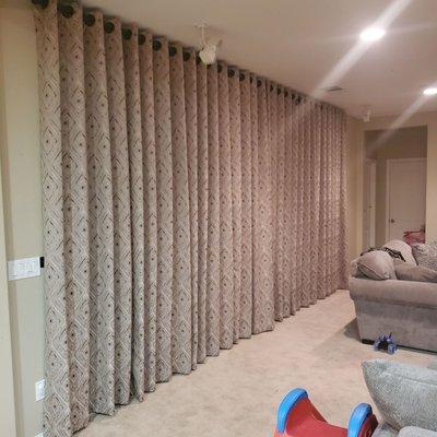 Beautiful family room. Curtains cover the sliding glass doors.