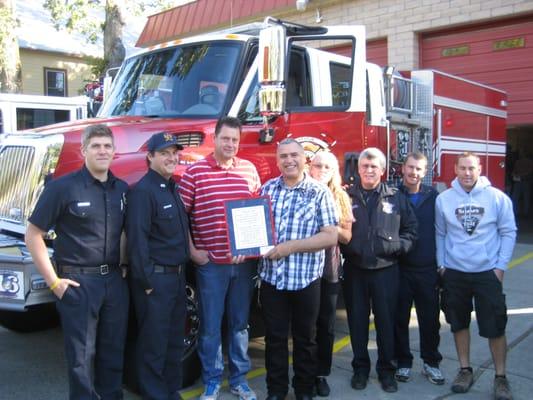 Presenting a plaque of appreciation to the Rescue F.D. for saving Eric's Life