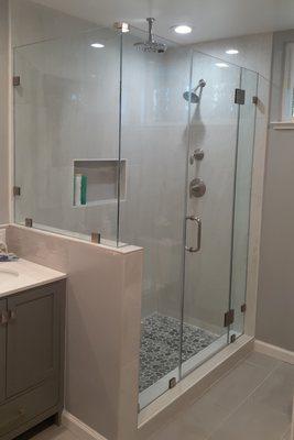 recently installed frameless style shower enclosure with pony wall.