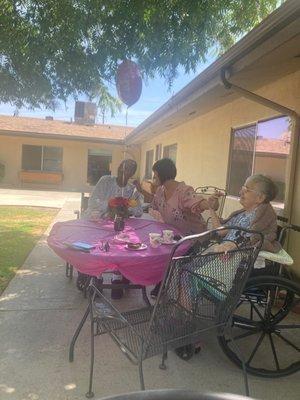 Family and residents having Mother's Day Tea Time..