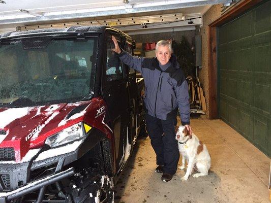 Gene and Remmi by our Polaris 1000 on a snowy winter day in the Utah mountains