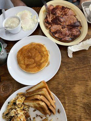 Ham Steak and Egg (over medium) Plate with grits and a short stack.