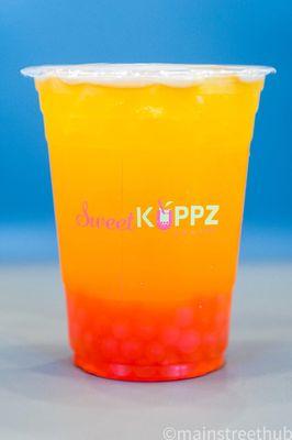 Mango flavor tea with straw popping boba