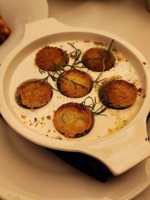 Escargot topped with toasted coins of bread