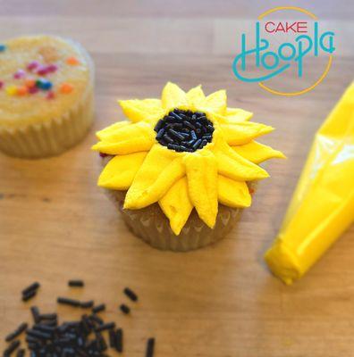 A sunflower cupcake and decorating ingredients for a fall-themed DIY cupcake-decorating workshop in Tigard, Oregon near Portland.