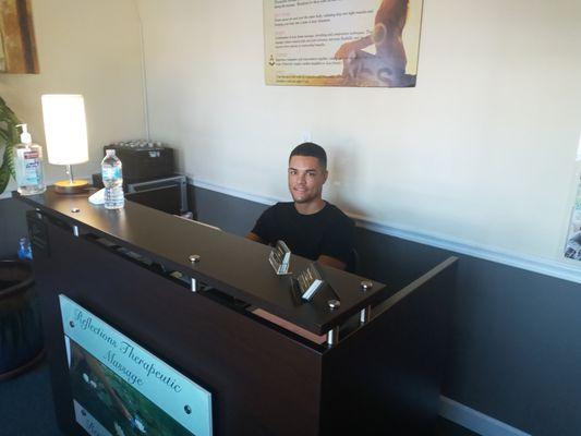 Caleb at reception desk