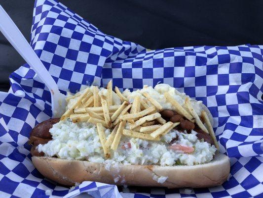 The Picnic Basket hot dog; Mettwurst, maple bacon baked beans, creamy cole slaw, potato salad, topped with potato sticks.