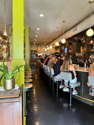 Bar seating and community table on left! See the diner-look chairs? Love it!