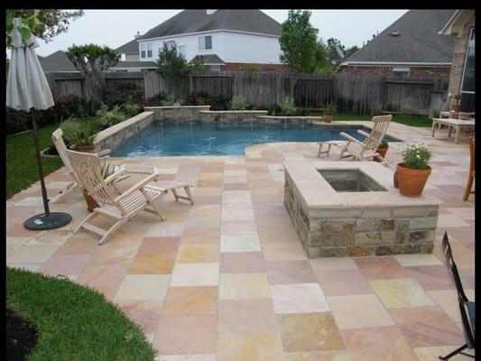 A clean design with a cut flagstone deck. The natural materials make this backyard a personal oasis.