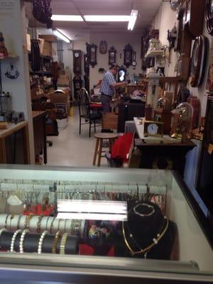 Old man busy working on a clock.