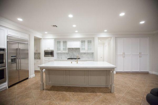 Kitchen refinish with quartz counter tops and marble back splash in a herringbone pattern