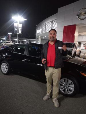 My car salesman, Jessie, with the keys to my brand new 2025 Nissan Sentra! He's the best.