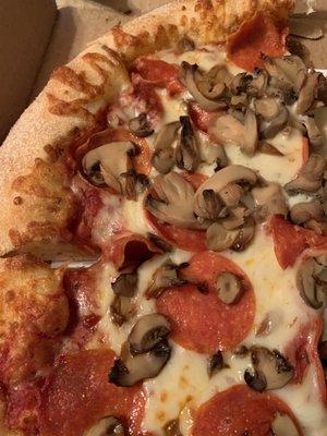 Close up of pepperoni and mushrooms