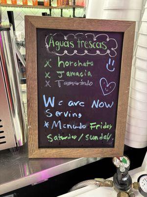 Counter menu with "We are now serving Menudo Friday, Saturday/Sunday."