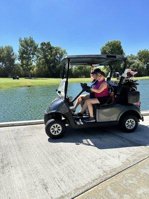 Pushing along in the golf cart to the next hole ‍