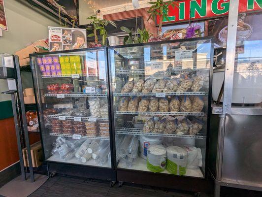 Glass case with fried chicken skins, chicharon, peanuts, hopia