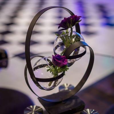 Elegant purple floral in our wrought iron centerpieces.