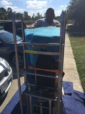 Movers preparing to move upright piano upstairs!