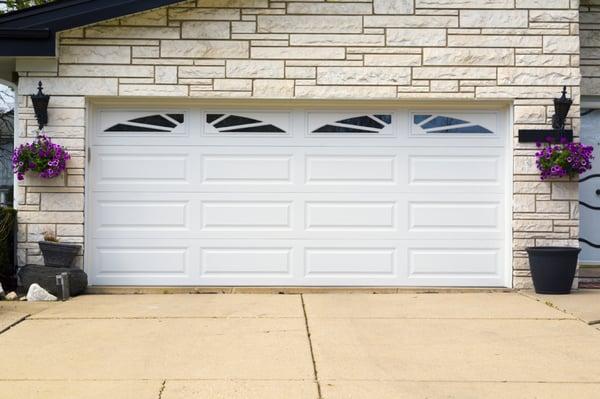 2 car garage steel sectional overhead garage door in Redmond Oregon. Long pannel design. Sunray window design. Geine garage door opener.